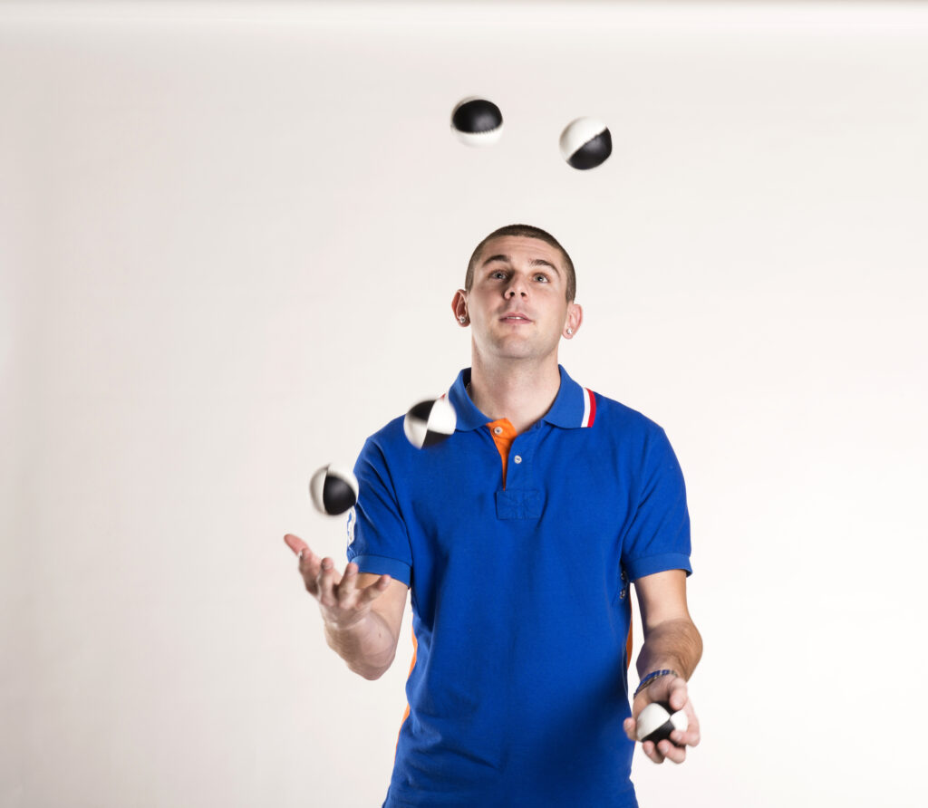Man Juggling black and white balls