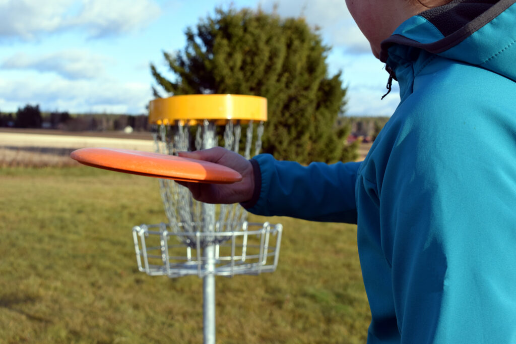 Person throwing disc golf